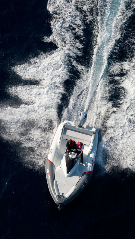 Vue d'ensemble d'un bateau équipé d'un moteur Honda, utilisé par des démonstrateurs, sur le littoral.